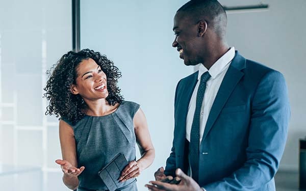 Two colleagues having a discussion in a modern office