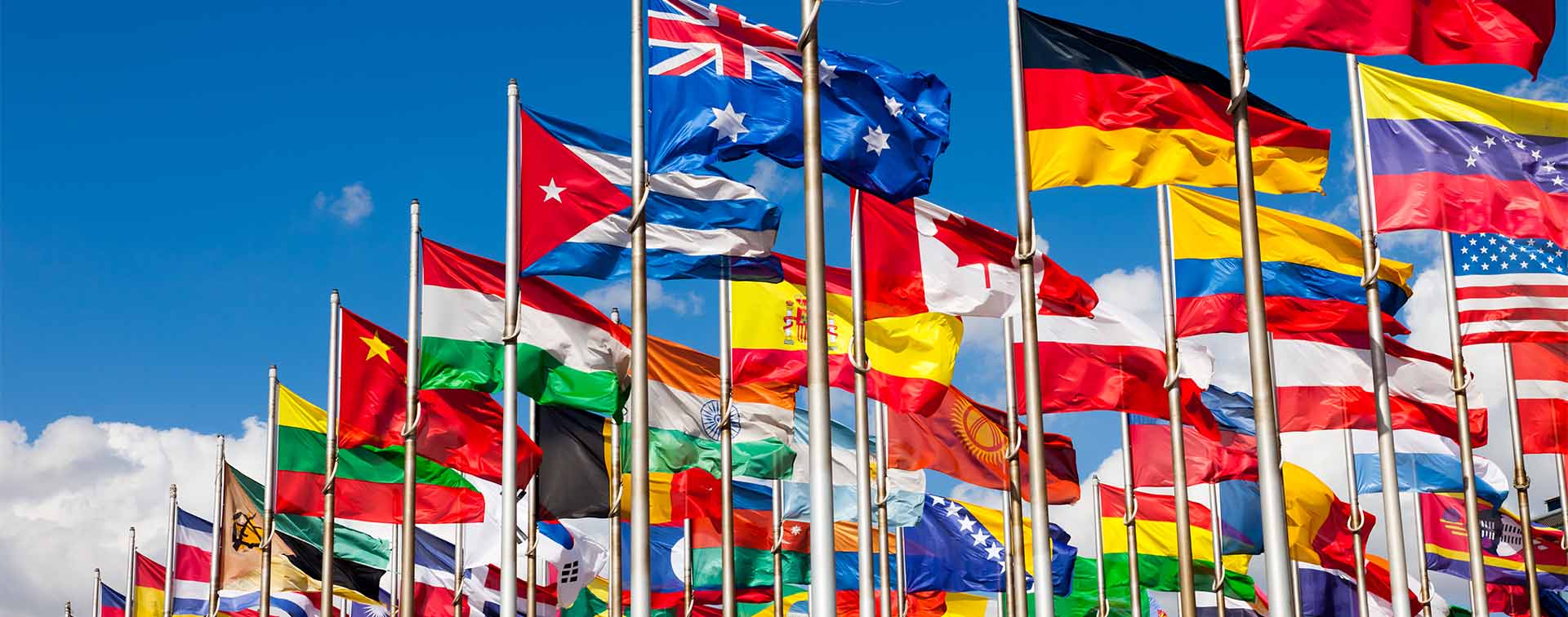 A plethora of national flags from around the world blowing in the wind