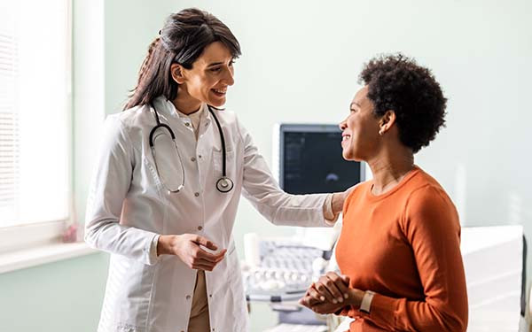 Female medical practitioner reassuring a patient