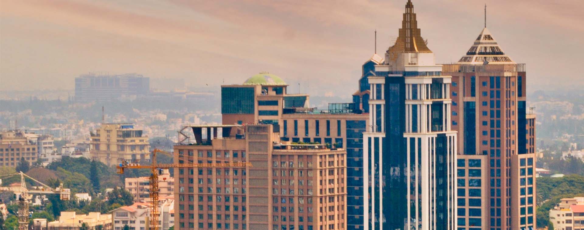 Cityscape view of modern buildings in the city against clear sky during sunset