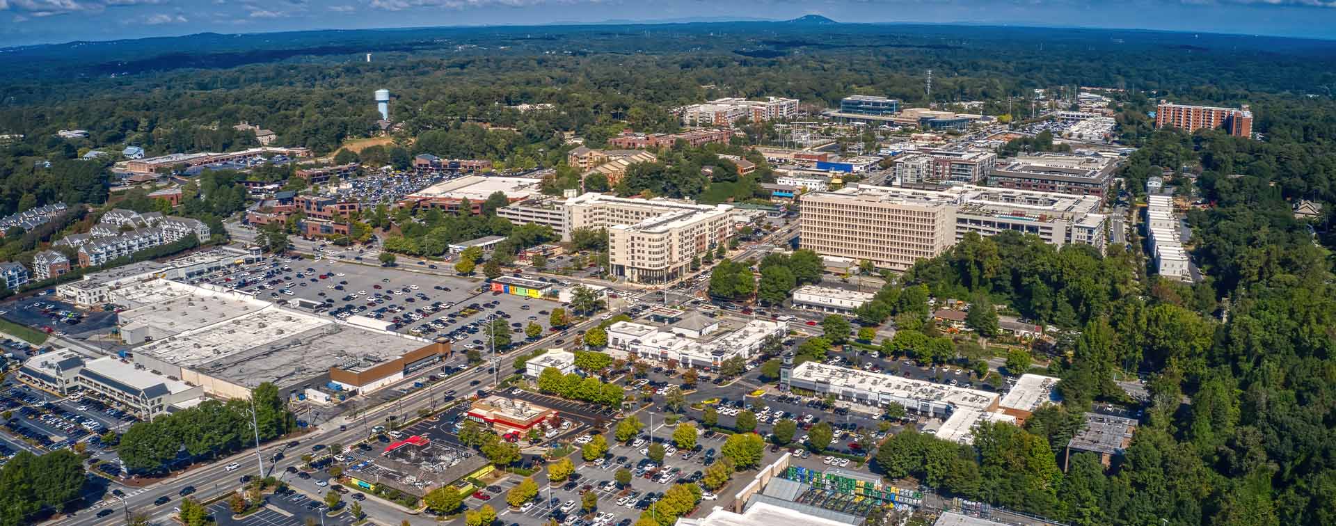 Aerial view of the Atlanta suburb of Sandy Springs under a blue sky with tiny clouds in Georgia