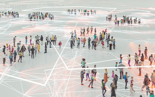 Aerial view of people standing spread out in groups across a patterned floor